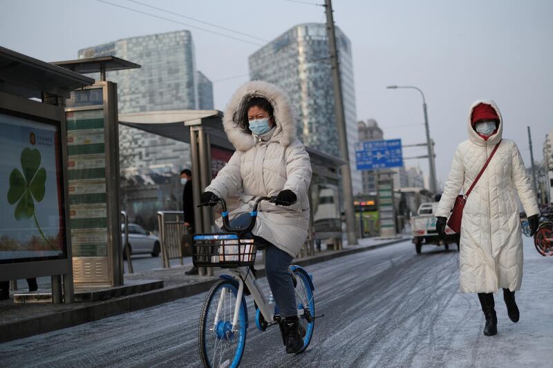 A woman rides a bicycle on a snowy morning in Beijing, China. Reuters