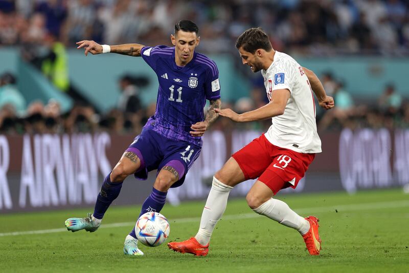 Angel Di Maria of Argentina fights for possession with Bartosz Bereszynski of Poland. Getty 