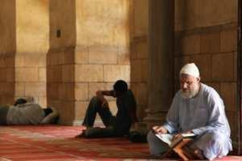 An Egyptian man reads the Koran at Al Azhar Mosque, the highest institution of Sunni Islam, in Cairo, Egypt on July 3, 2009. According to a recent poll, Egyptians are the most religious people in the world. Photo: Victoria Hazou *** Local Caption ***  VH_religiosity02.jpg