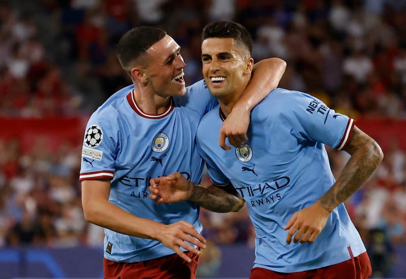 Phil Foden celebrates scoring City's second goal with Joao Cancelo. Reuters