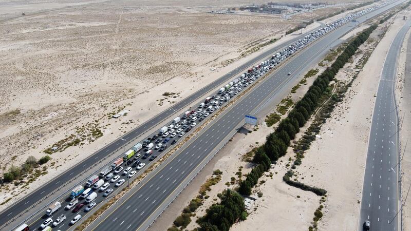 A picture taken with a drone shows cars queuing before a security checkpoint on the E11 highway, between Dubai and Abu Dhabi on June 6. EPA