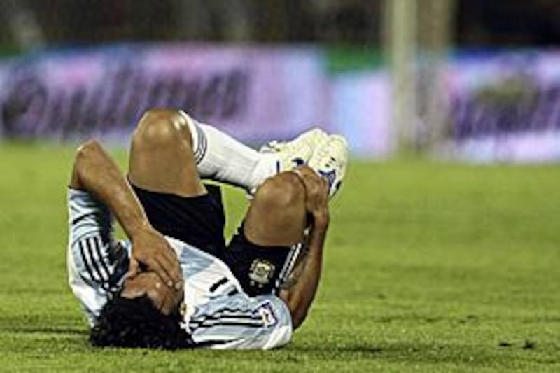 Carlos Tevez goes down injured during Argentina's 3-1 defeat to Brazil in Rosario on Saturday.