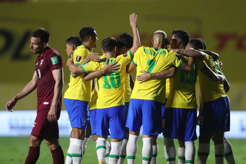 Brazil's Roberto Firmino celebrates with teammates after scoring his side's goal against Venezuela. AP