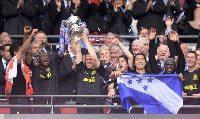 LONDON, ENGLAND - MAY 11:  Emmerson Boyce (L) and Gary Caldwell (R) of Wigan Athletic lift the trophy following their team's 1-0 victory during the FA Cup with Budweiser Final between Manchester City and Wigan Athletic at Wembley Stadium on May 11, 2013 in London, England.  (Photo by Mike Hewitt/Getty Images)