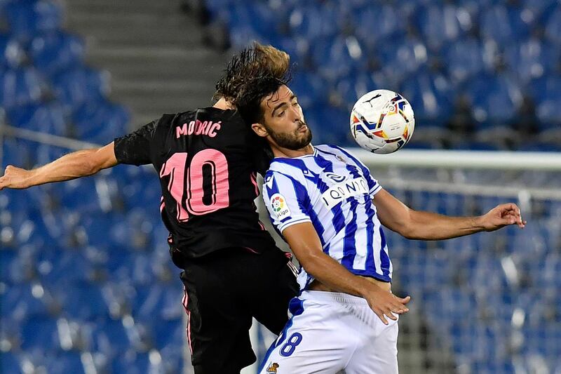 Real Sociedad's Mikel Merino jumps for the ball against Real Madrid's Luka Modric. AP Photo