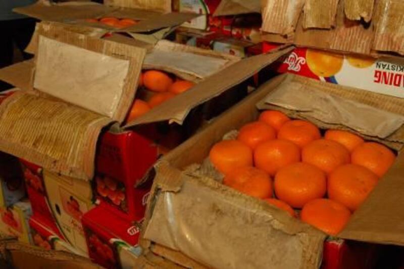 June 6, 2011-
The seized 58 kilograms of heroin were shipped in from Afghanistan via Pakistan in over 700 orange cartons and stored in the Dubai Fruits and Vegetable market.

- The drugs were concealed in the inside flaps of the orange cartons to avoid detection by customs inspectors and police.

Provided photos of a drug bust
Courtesy Dubai Police 