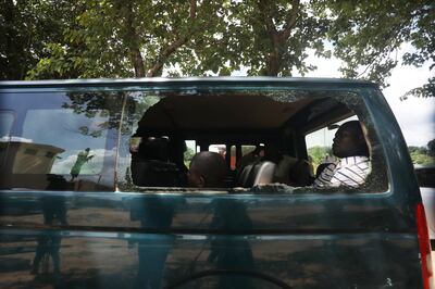 Recaptured inmates sit inside a prison vehicle in Abuja, Nigeria, on July 6.  Boko Haram gunmen are suspected of attacking the Kuje Medium Prison. EPA