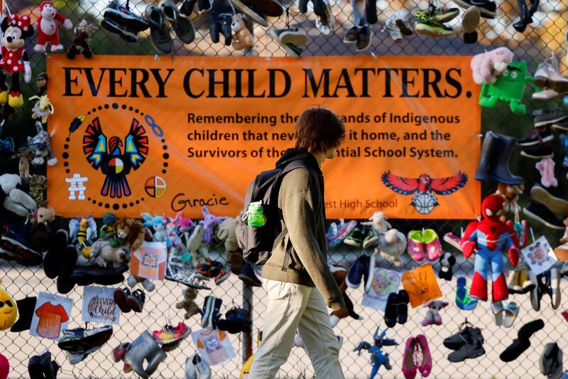 A student walks past a display at Hillcrest High School on Canada's first National Day for Truth and Reconciliation, honouring the lost children and survivors of indigenous residential schools in Ottawa, Ontario. Reuters