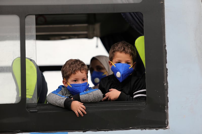 Children wearing protective face masks are pictured on a bus in Algiers, Algeria. Reuters