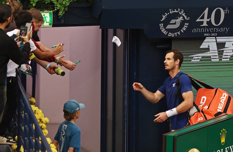 Andy Murray throws his wristband to fans after losing his round of 16 match against France's Ugo Humbert. Reuters