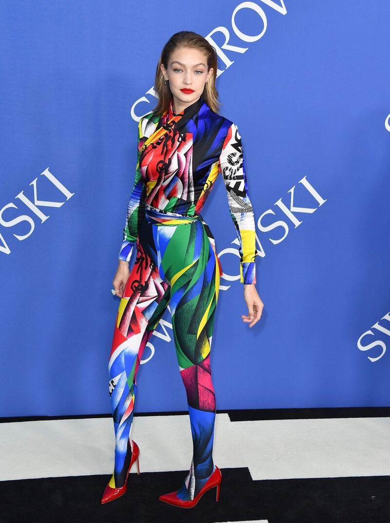 Gigi Hadid in a Versace jumpsuit (and yes, it is footed, her trou' do transform into tights). AFP