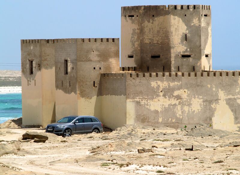 An Audi Q7 rests while its driver and passengers explore an abandoned fort near the sea in Mirbat, east of Salalah city - Paolo Rossetti for The National