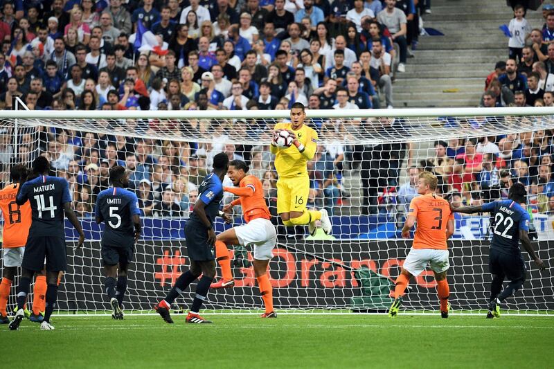 France's goalkeeper Alphonse Areola jumps to catch the ball during the UEFA Nations League football match between France and Netherlands at the Stade de France stadium, in Saint-Denis, northern of Paris, on September 9, 2018. / AFP PHOTO / FRANCK FIFE
