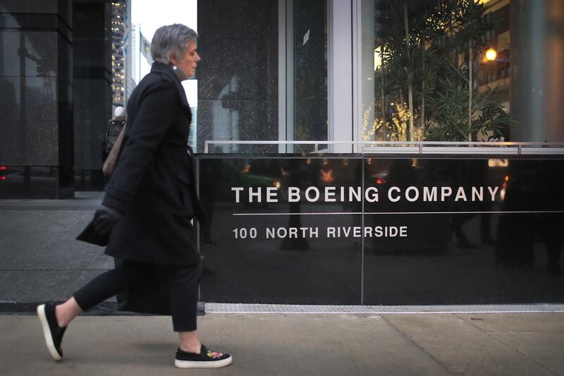 CHICAGO, ILLINOIS - JANUARY 29: A pedestrian walks by the headquarters of The Boeing Company on January 29, 2020 in Chicago, Illinois. Boeing said today that costs associated with grounding the 737 Max aircraft were likely to exceed $18 billion.   Scott Olson/Getty Images/AFP