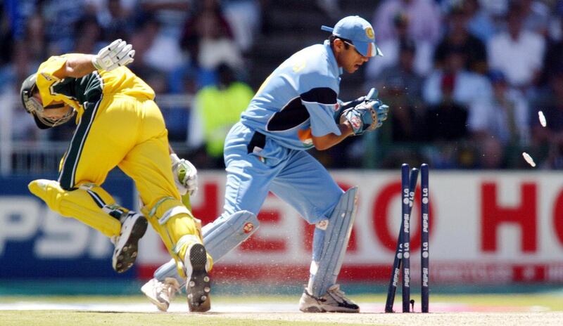 Australian captain Ricky Ponting (L) dives for his crease as Indian wicketkeeper Rahul Dravid takes the bails off in the final of the ICC Cricket World Cup being played at the Wanderers Stadium in Johannesburg 23 March 2003.  Batting first, Australia scored 359-2 from their 50 overs, their highest ever one-day total.  AFP PHOTO/William WEST (Photo by WILLIAM WEST / AFP)