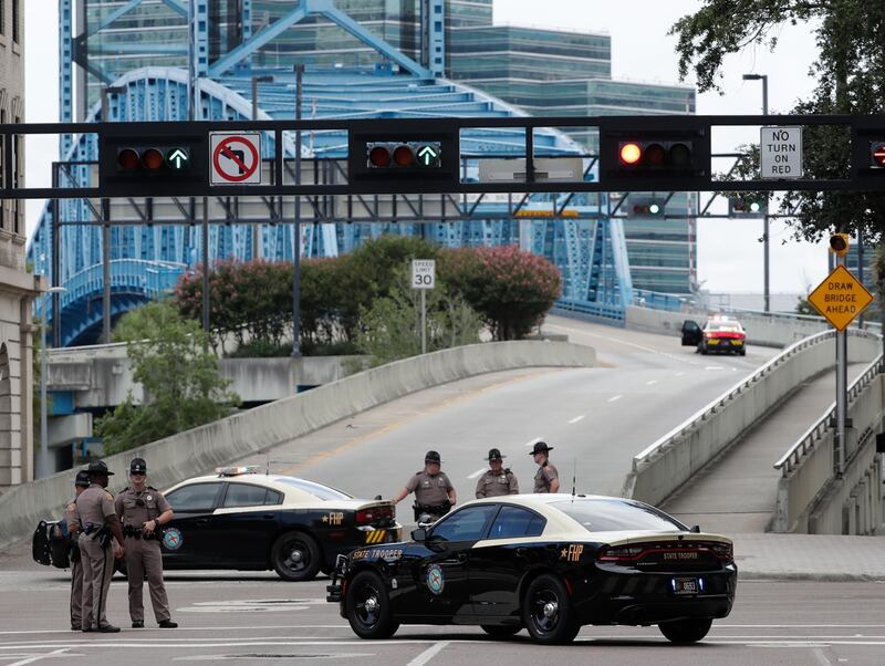 Florida Highway patrolmen block the entrance to the Main Street Bridge near the scene of a mass shooting at Jacksonville Landing. AP Photo
