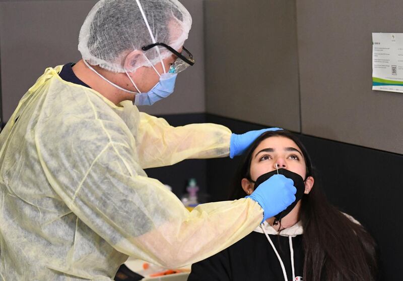 A health worker checks a passenger. AFP