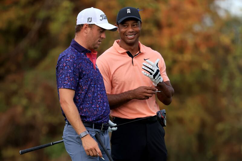 Tiger Woods and Justin Thomas wait on the 18th hole. AFP