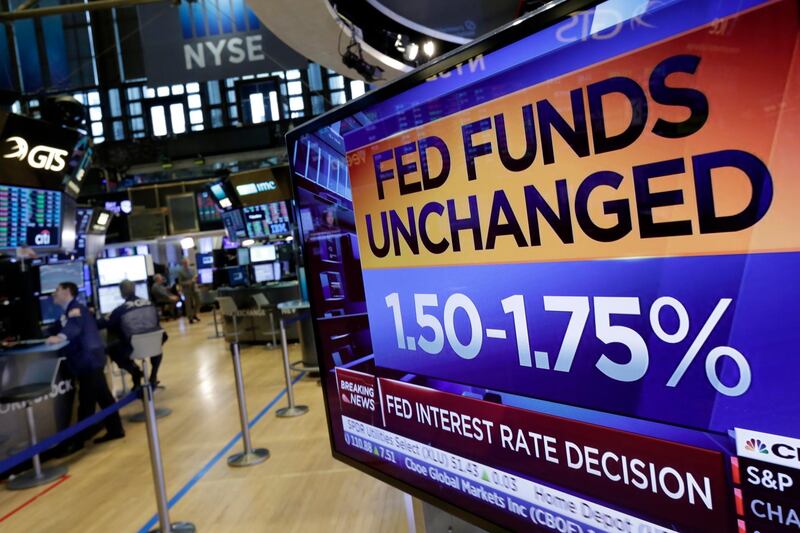 A screen on the floor of the New York Stock Exchange shows the rate decision of the Federal Reserve, Wednesday, May 2, 2018. The Federal Reserve is keeping its benchmark interest rate unchanged but says that inflation is climbing after years of being stuck below the Fed's target level. (AP Photo/Richard Drew)