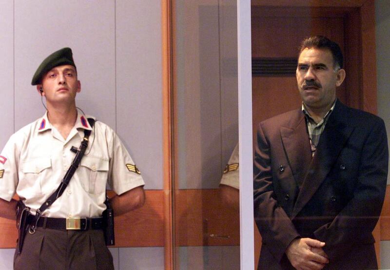 In this June 29, 1999 photo, Kurdish rebel leader Abdullah Ocalan (right) stands next to a Turkish gendarme during his trial on the prison island of Imrali, Turkey. Abdurrahman Antakyali, Anatolia, File/AP Photo