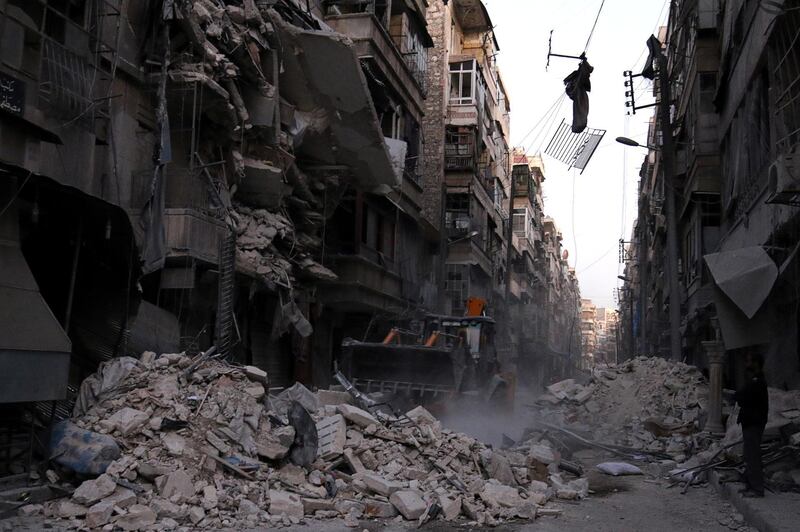 Civil Defense members work at a site hit by an airstrike in the rebel-held al-Shaar neighbourhood of Aleppo, Syria, September 27, 2016. REUTERS/Abdalrhman Ismail