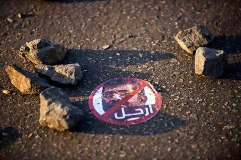 A sticker urging the Egyptian president Mohamed Morsi to leave lies near the presidential palace in Cairo yesterday. Gianluigi Guercia / AFP