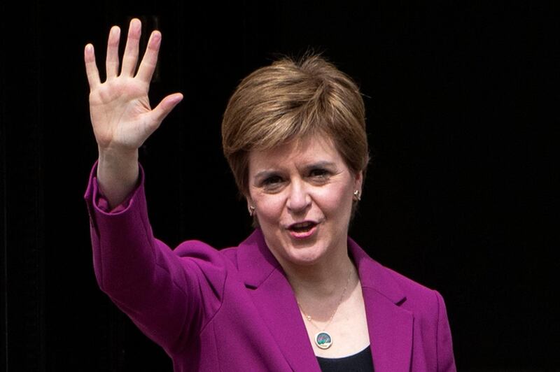Scotland's First Minister and leader of the Scottish National Party (SNP), Nicola Sturgeon waves on the steps of her official residence Bute House in Edinburgh on May 9, 2021 following the party's landslide victory in the Scottish parliament elections. The Scottish National Party on May 9 said its landslide victory in Edinburgh's devolved parliament was grounds for a fresh independence referendum, despite opposition from London. / AFP / Andy Buchanan
