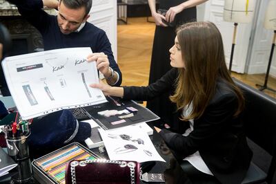 Kaia Gerber overlooks sketches for the collection 