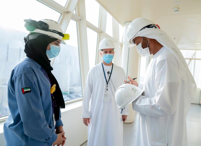 AL DHAFRA, ABU DHABI, UNITED ARAB EMIRATES - June 11, 2020: HH Sheikh Mohamed bin Zayed Al Nahyan, Crown Prince of Abu Dhabi and Deputy Supreme Commander of the UAE Armed Forces (R) signs a helmet of a member of the Emirates Nuclear Energy Corporation, during the inspection of the Barakah Peaceful Nuclear Energy Plants, in Barakah. Seen with HE Mohamed Al Hammadi, CEO Emirates Nuclear Energy Corporation (ENEC) (C).

( Mohamed Al Hammadi / Ministry of Presidential Affairs )
---