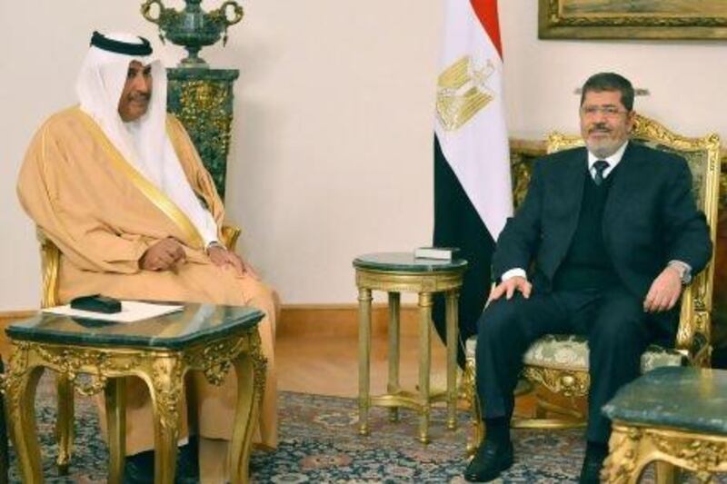 Egyptian president Mohammed Morsi (right) meets with Qatari prime minister and foreign minister Hamad bin Jassim Al Thani. Qatar is to increase its financial aid to Egypt by $2.5 billion.