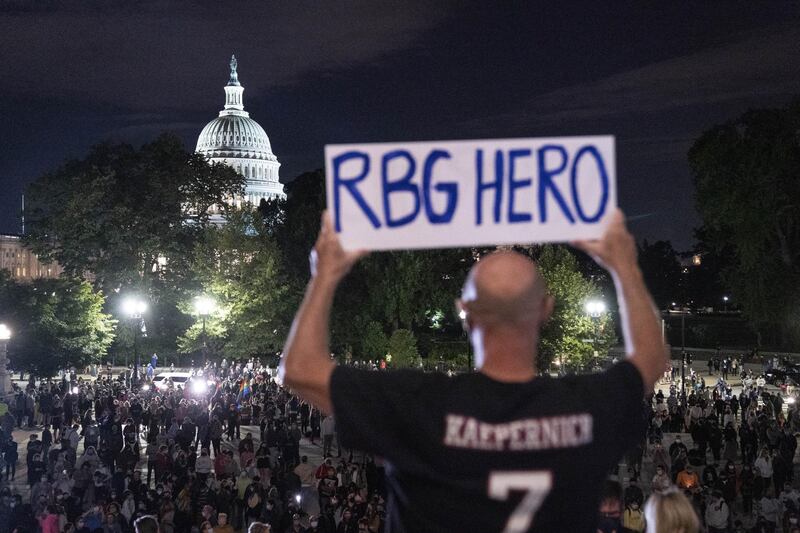 A man holds a sign reading "RBG HERO" as mourners hold a vigil for Ruth Bader Ginsburg outside the US Supreme Court in Washington. Bloomberg
