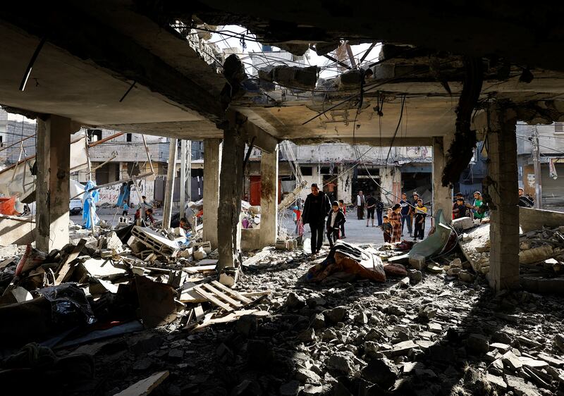 Palestinians inspect the site of an Israeli strike on a house in southern Gaza on Wednesday. Reuters