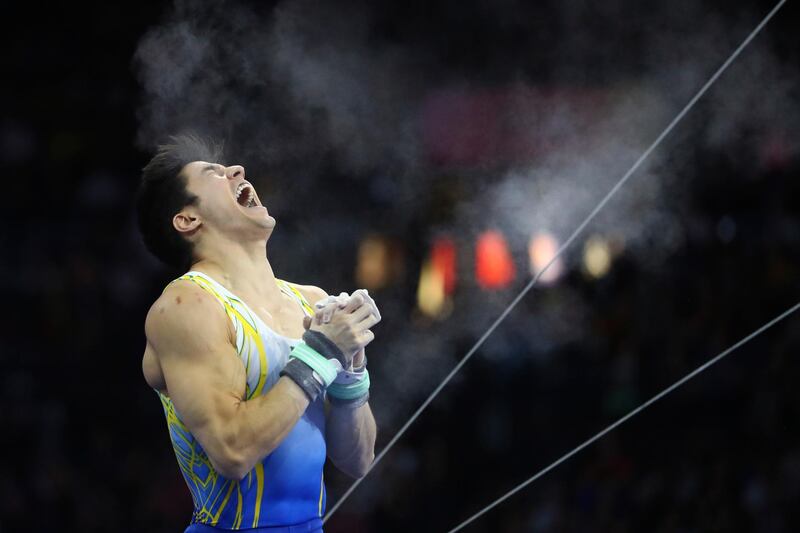 Gold medalist Arthur Mariano of Brazil celebrates after the horizontal bear exercise in the men's apparatus finals at the Gymnastics World Championships in Stuttgart, Germany.  AP