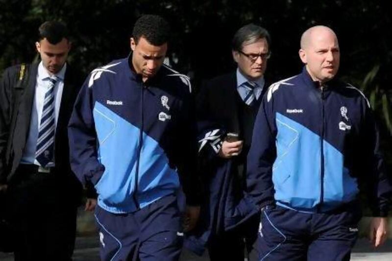 Bolton Wanderers player Tyrone Mears, second left, and club doctor Jonathan Tobin, right, arrive with other club officials yesterday at the hospital in London where Fabrice Muamba is in intensive care.