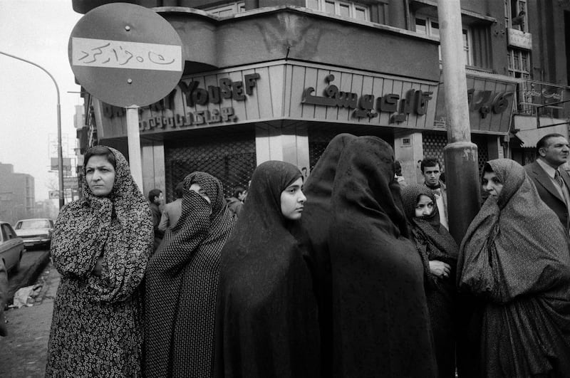 Chador-clad women stand in front of a 'Shah ran' slogan sprayed on a street sign in Tehran a few days after the Shah fled the country, on January 19, 1979. Getty Images