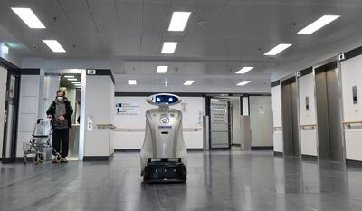 Cleaning robot 'Franzi' cleans in the entrance area of a hospital in Munich Neuperlach, southern Germany, on February 12, 2021.  Cleaning robot Franzi always makes sure the floors are spotless at the Munich hospital where she works, but she has also taken on a new role in the pandemic: cheering up patients and staff. - TO GO WITH AFP STORY BY PAULINE CURTET
 / AFP / Christof STACHE / TO GO WITH AFP STORY BY PAULINE CURTET
