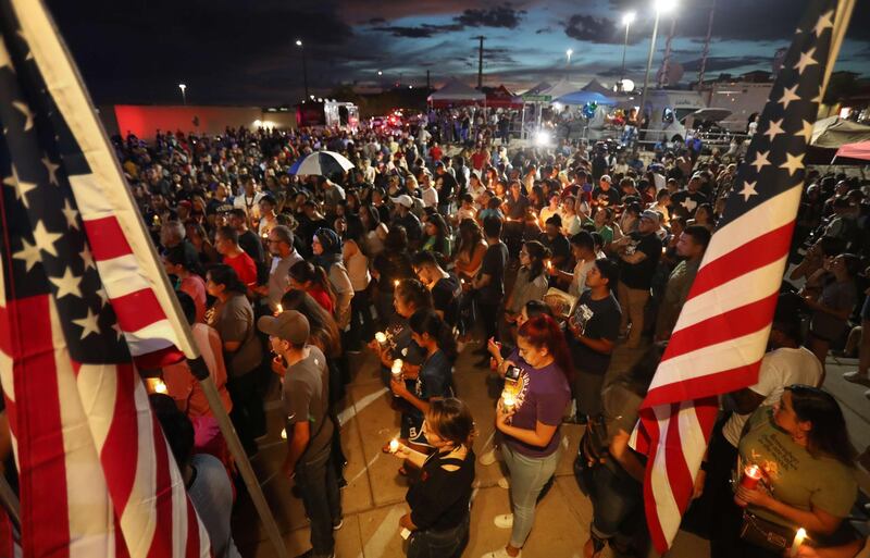 EL PASO, TEXAS - AUGUST 07: People attend a candlelight vigil at a makeshift memorial honoring victims of a mass shooting which left at least 22 people dead, on August 7, 2019 in El Paso, Texas. President Donald Trump visited the city earlier today. A 21-year-old white male suspect remains in custody in El Paso which sits along the U.S.-Mexico border.   Mario Tama/Getty Images/AFP
== FOR NEWSPAPERS, INTERNET, TELCOS & TELEVISION USE ONLY ==
