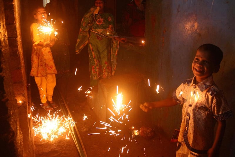 Pakistani Hindu children play with fire crackers during Diwali festival celebrations in Hyderabad, Pakistan.  EPA