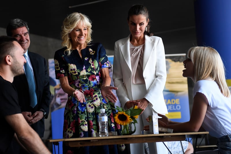 US first lady Jill Biden, centre left, and Spain's Queen Letizia speak with a family during a visit to a reception centre for Ukrainian refugees in Madrid. AP