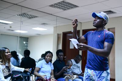 Ologbenla Benjamin, music director for the Garden of Peace Choir leads practice for Sunday mass. Khushnum Bhandari / The National
