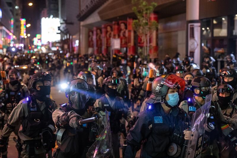 Riot police stand guard on Portland Street in the Mong Kok district of Hong Kong, China. Bloomberg