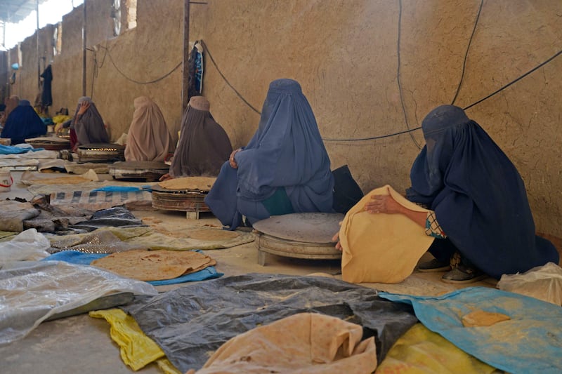 Afghan women workers prepare bread to sell in a market in Kandahar. AFP