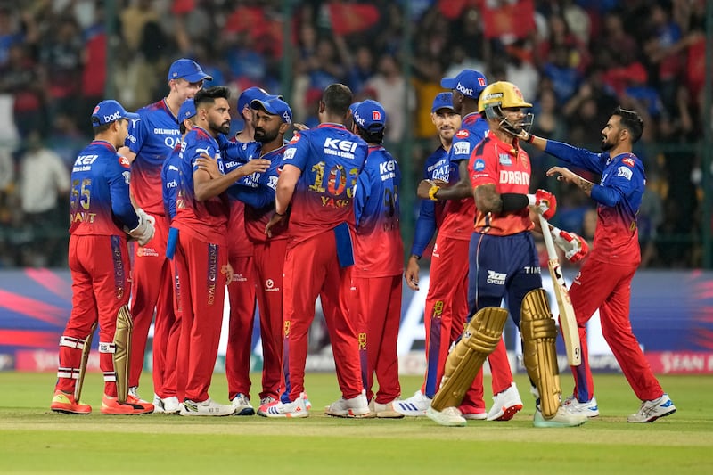 Royal Challengers Bengaluru's Mohammed Siraj, without cap, celebrates with teammates after the dismissal of Punjab Kings' Jonny Bairstow, caught by Virat Kohli for 8. AP