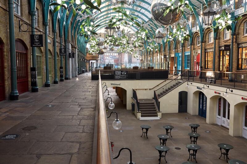 Cafe tables stand without chairs in Covent Garden. Getty Images