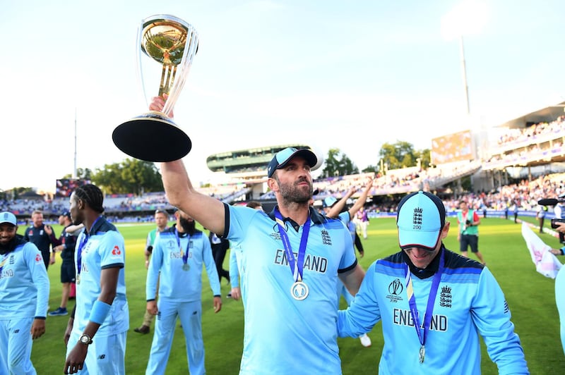 LONDON, ENGLAND - JULY 14: Liam Plunkett and Eoin Morgan of England celebrate with the trophy after winning the Final of the ICC Cricket World Cup 2019 between New Zealand and England at Lord's Cricket Ground on July 14, 2019 in London, England. (Photo by Gareth Copley-ICC/ICC via Getty Images)
