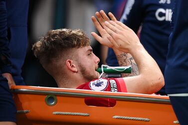 LEEDS, ENGLAND - SEPTEMBER 12: Harvey Elliott of Liverpool applauds the fans as he leaves the pitch on a stretcher following an injury during the Premier League match between Leeds United and Liverpool at Elland Road on September 12, 2021 in Leeds, England. (Photo by Laurence Griffiths / Getty Images)