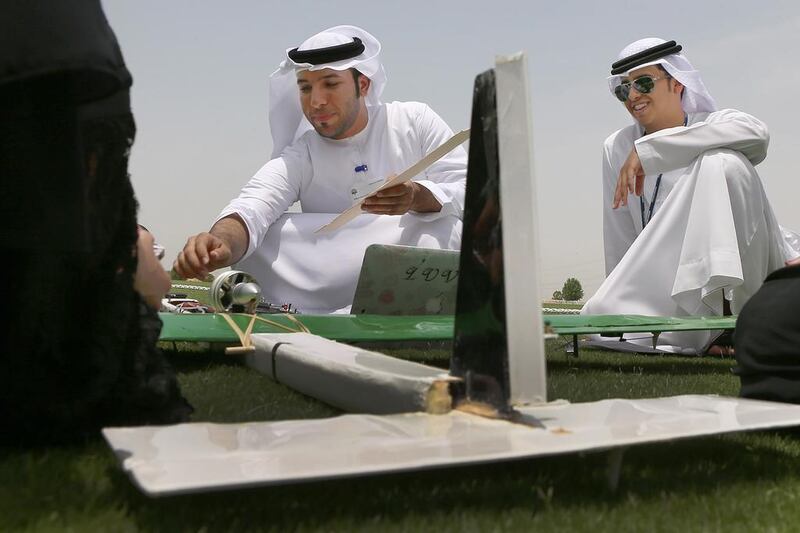 Al Ain College students Faisal Al Naqbi (left) and Husain along with other Flight 19 team members. Delores Johnson / The National