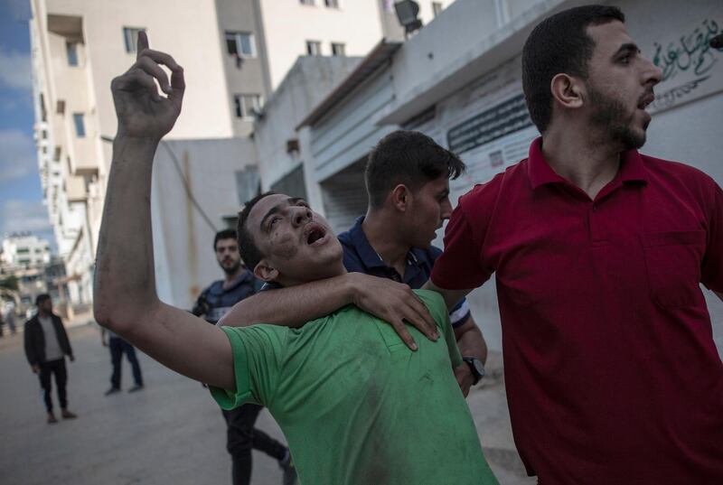 A Palestinian man reacts to the death of his father who was killed by an Israeli airstrike that destroyed the upper floors of a commercial building and caused damage to a health ministry and prime health care clinic in Gaza city. AP Photo