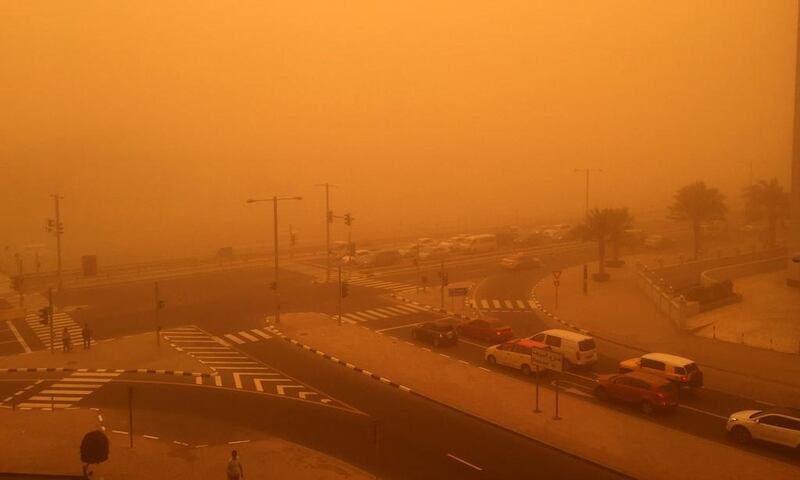 Cars are seen driving amid a sandstorm that engulfed the city of Dubai. Marwan Naamani / AFP Photo