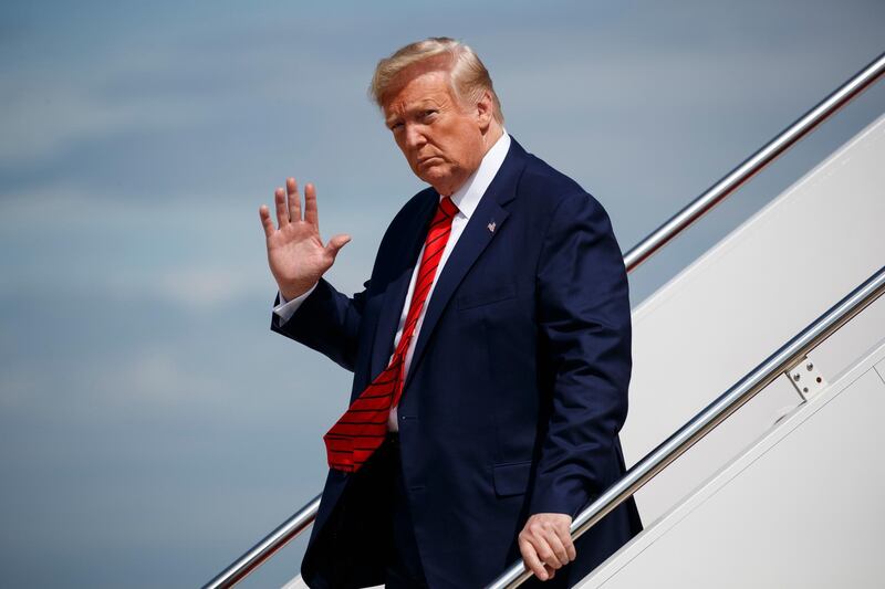 In this Sept. 26, 2019 photo, President Donald Trump waves to reporters as he steps off Air Force One after arriving at Andrews Air Force Base, in Andrews Air Force Base, Md. A whistle blew, an impeachment inquiry swung into motion and the president at the center of it all rose defiantly to his own defense, not always in command of the facts.  (AP Photo/Evan Vucci)